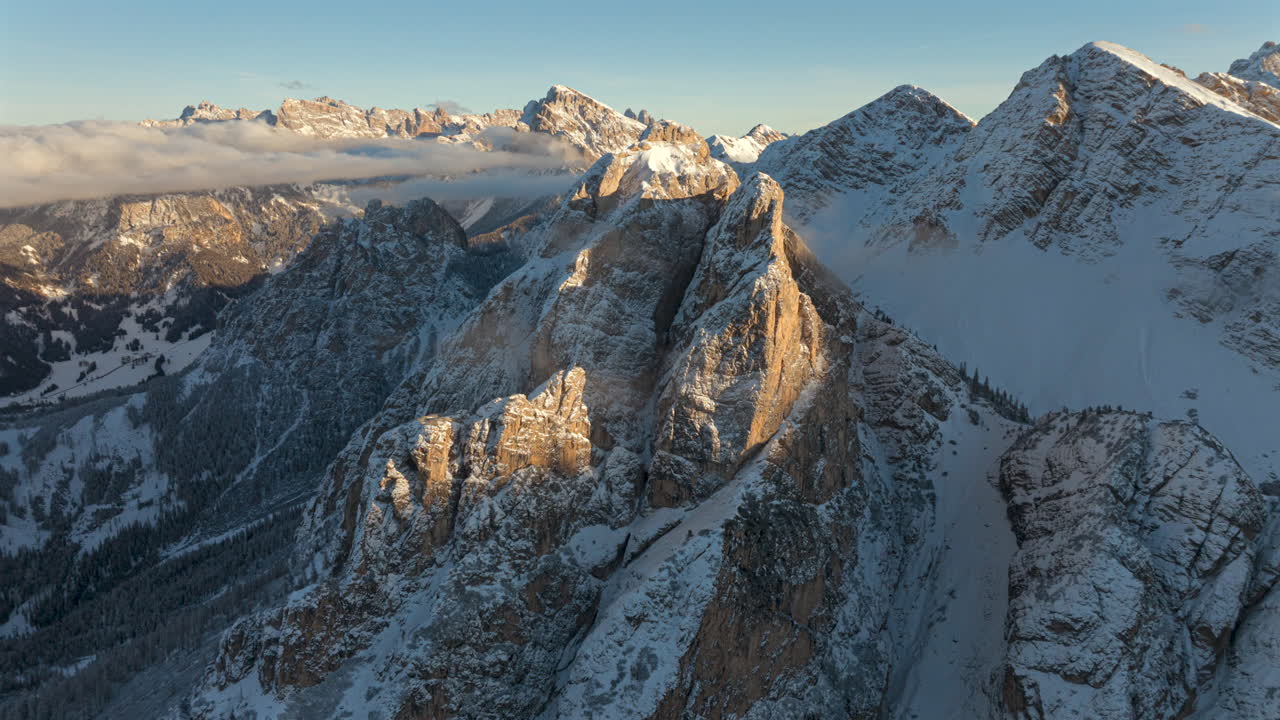 Aerial hyperlapse timelapse of Dolomites Mountains in winter season. Moving clouds at sunset