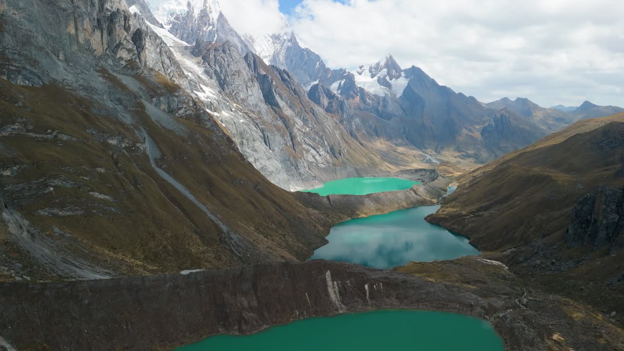 Stunning aerial view of turquoise glacial lakes nestled among dramatic peaks near the Huayhuash trekking circuit in the Peruvian Andes