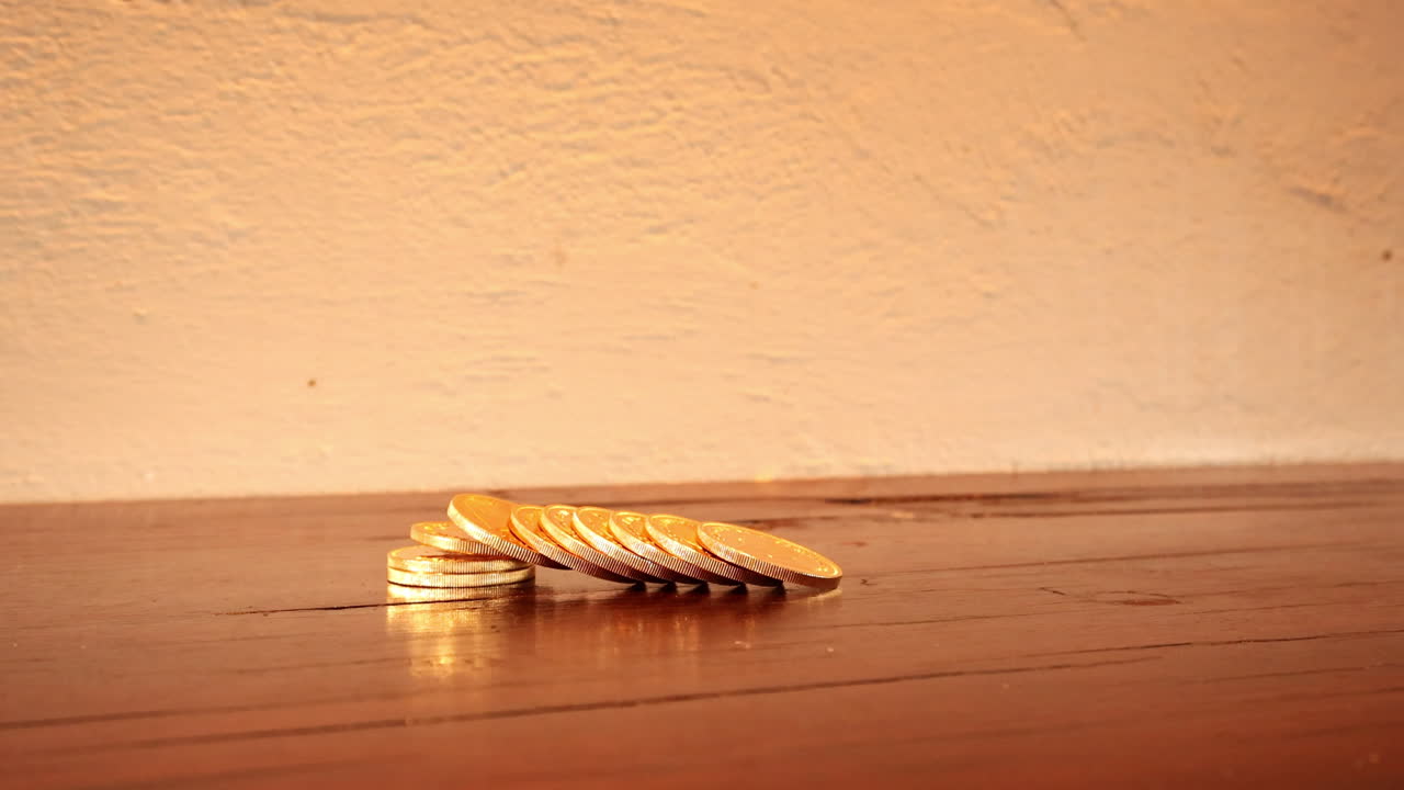 Closeup of rich guy spreads out valuable gold coins on table, savings concept
