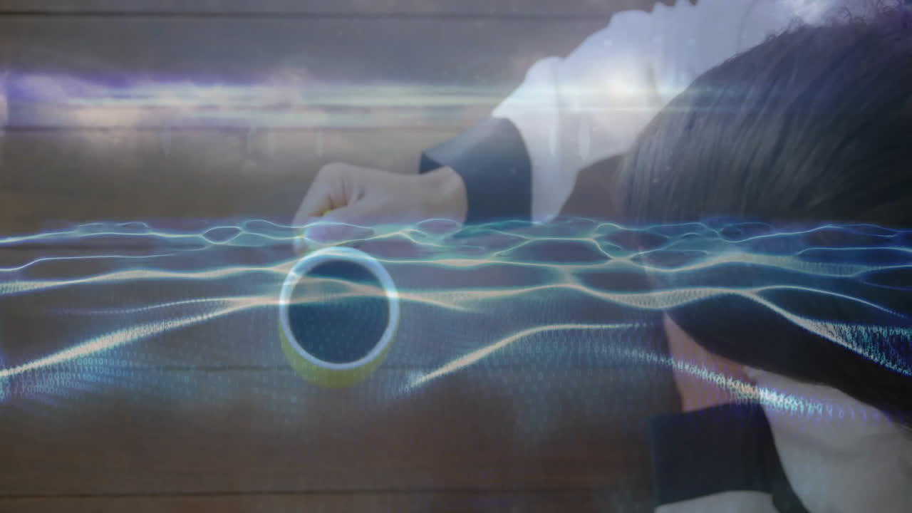 woman leaning over table while reaching for yellow mug, showcasing holographic technology waveforms