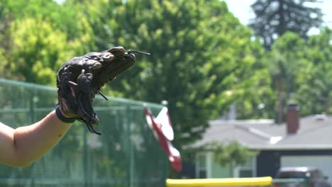 close up of person catching a ball while playing catch