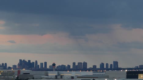 time-lapse of a city skyline with skyscraper buildings at the horizon at sunset, wide shot