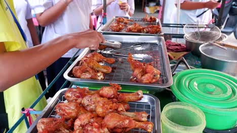 vendor arranging fried chicken at ayutthaya market