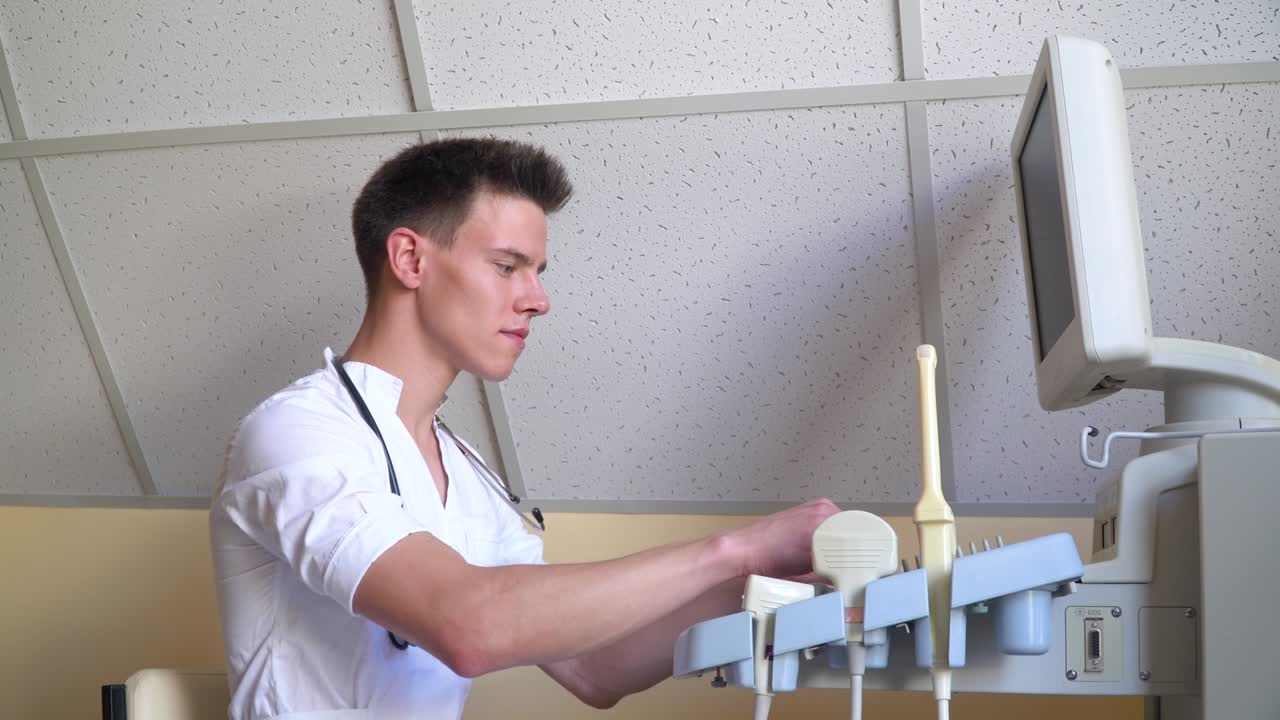 Young doctor working on ultrasound device. Diagnostics covid 19