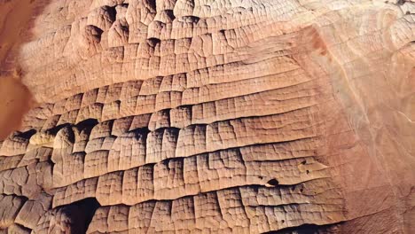 rocky cliffs and sandy ground on sunny day in desert terrain