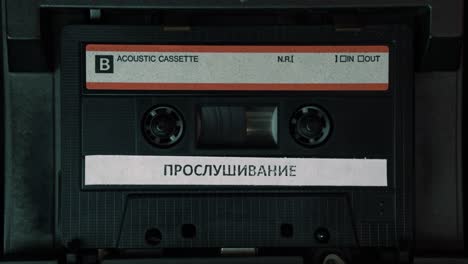 Russian-Wiretap-Audio-Recording-on-Cassette-Tape-Playing-in-Vintage-Deck-Player,-Close-Up