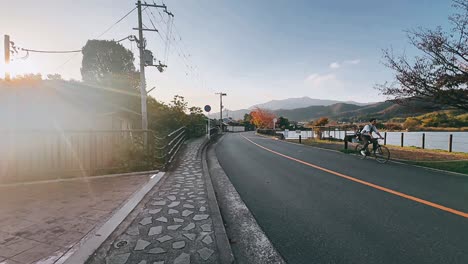 japanese countryside road at sunset with cyclist