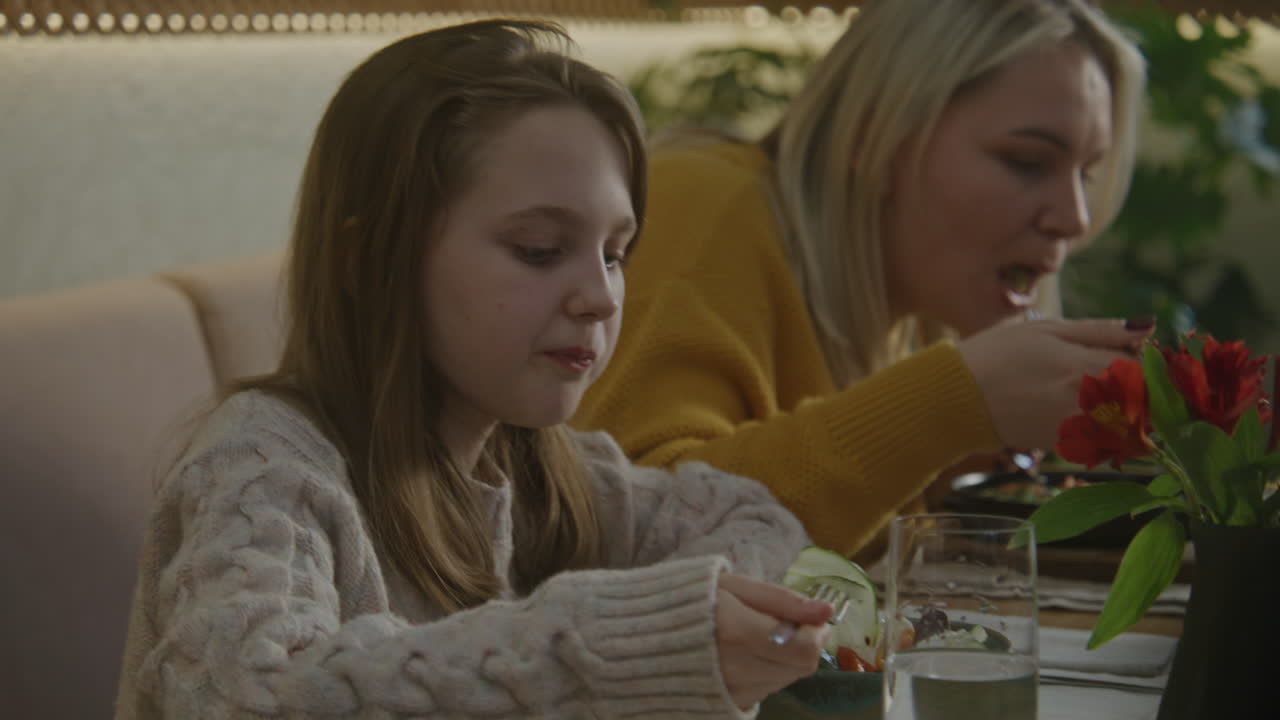 Mother and daughter eating in a restaurant