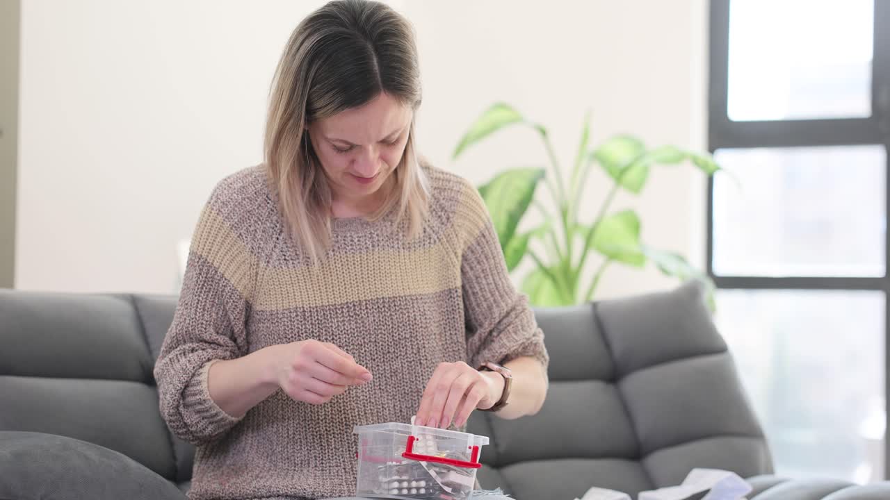 Woman sorting pills at home