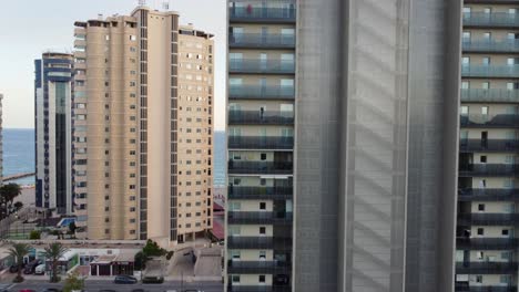 breathtaking drone clip through the hotels and building revealing the bay of town of calpe, spain