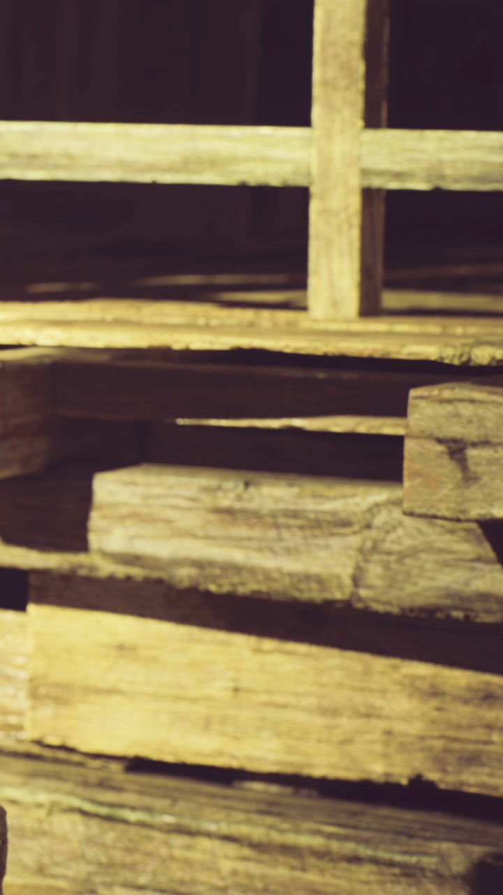 Wooden pallets stacked creatively in a rustic workshop on a golden afternoon