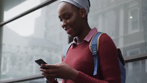 african american using her smartphone in street