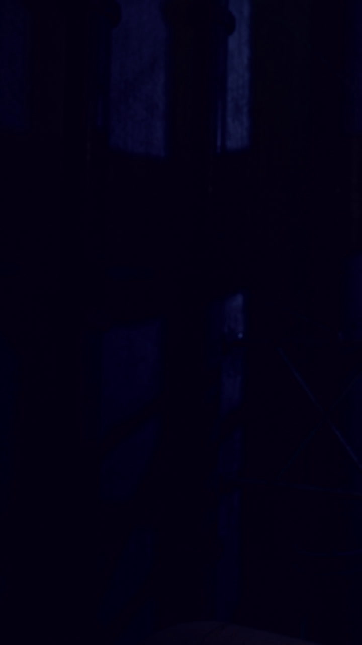 Dark setting with shadows and partial light in a narrow space at night