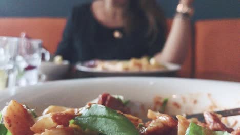 Young-attractive-girl-eating-delicious-dinner-in-restaurant