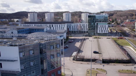 university of gdansk campus grounds, rectorate building and empty parking lot in front of faculties