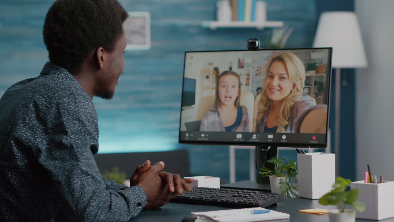 Selective focus on african american man talking with friends and family using online video call communication