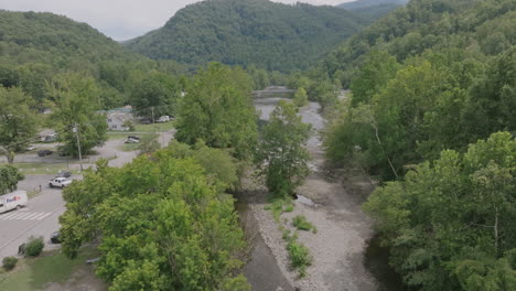 aerial footage over trees revealing a creekbed in western north carolina