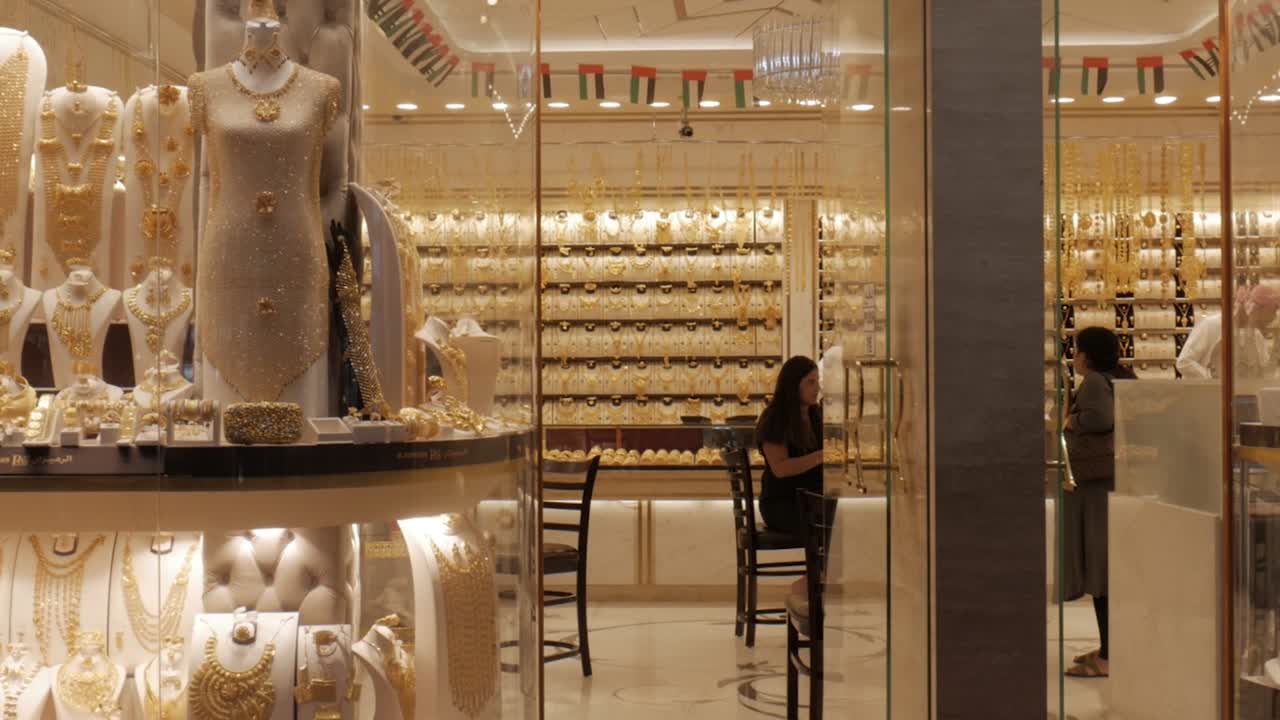 Jewellery gold store customers exiting at Deira Dubai, panning shot