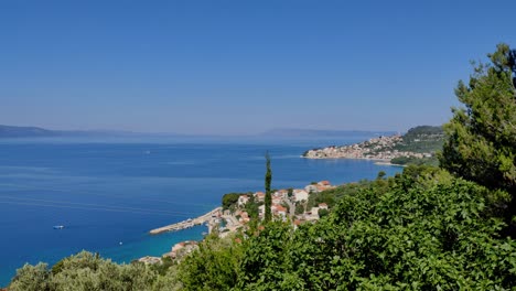 moving shot from top of croatian coast with town živogošće in the background