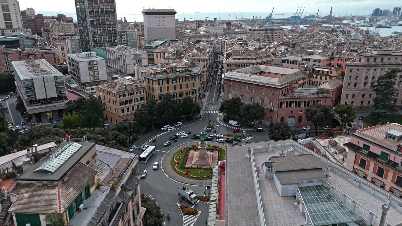 Traffic flow around Piazza Corvetto in Genoa, aerial view over rooftops