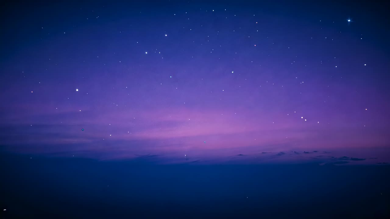 Deepening twilight causing sky showing violet gradient, stars drifting and specks above cloud bank