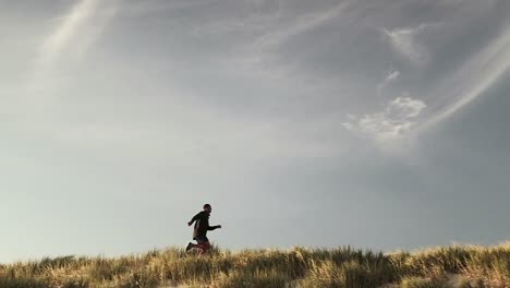 Man-running-on-grass-field
