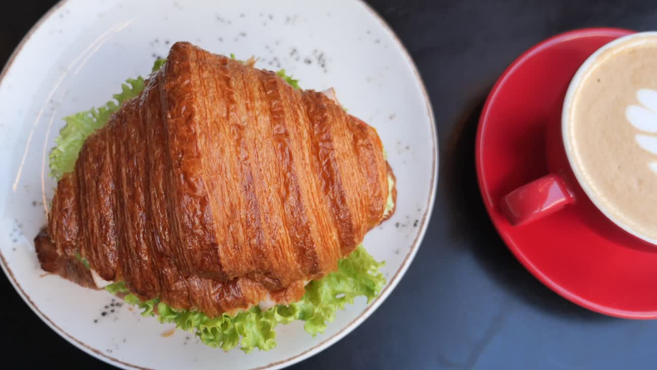 Croissant sandwich on a white plate