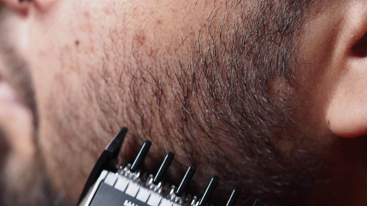Close-up of a man getting a beard trimmed