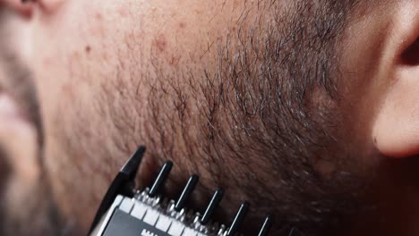 close-up of a man getting a beard trimmed