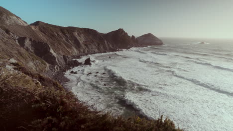 coastal landscape with waves crashing on rocks
