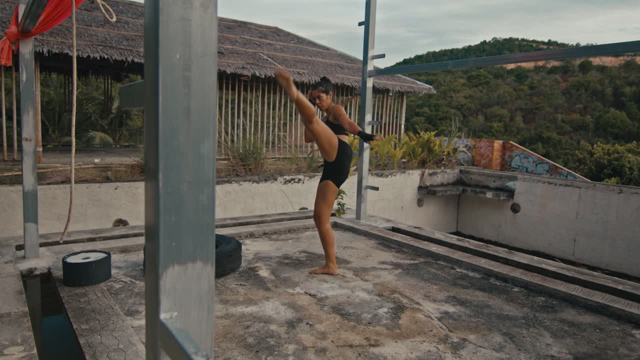 Woman Practicing Muay Thai on an Abandoned Rooftop