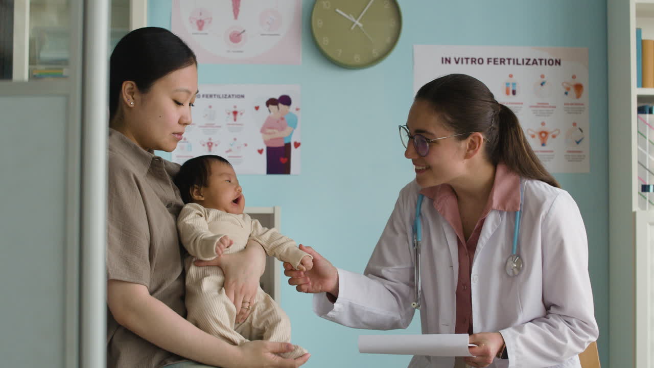 A mother and baby visit a pediatrician for a checkup