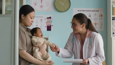 a mother and baby visit a pediatrician for a checkup