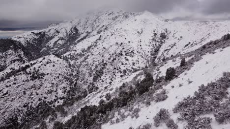 Stunning-aerial-of-vast-snowy-mountains,-Sardinia,-winter,-day,-dolly-in