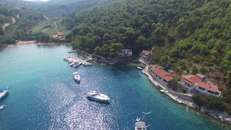 Yates-Y-Veleros-Anclados-En-Agua-Azul-Clara-Frente-A-Hvar,-Croacia