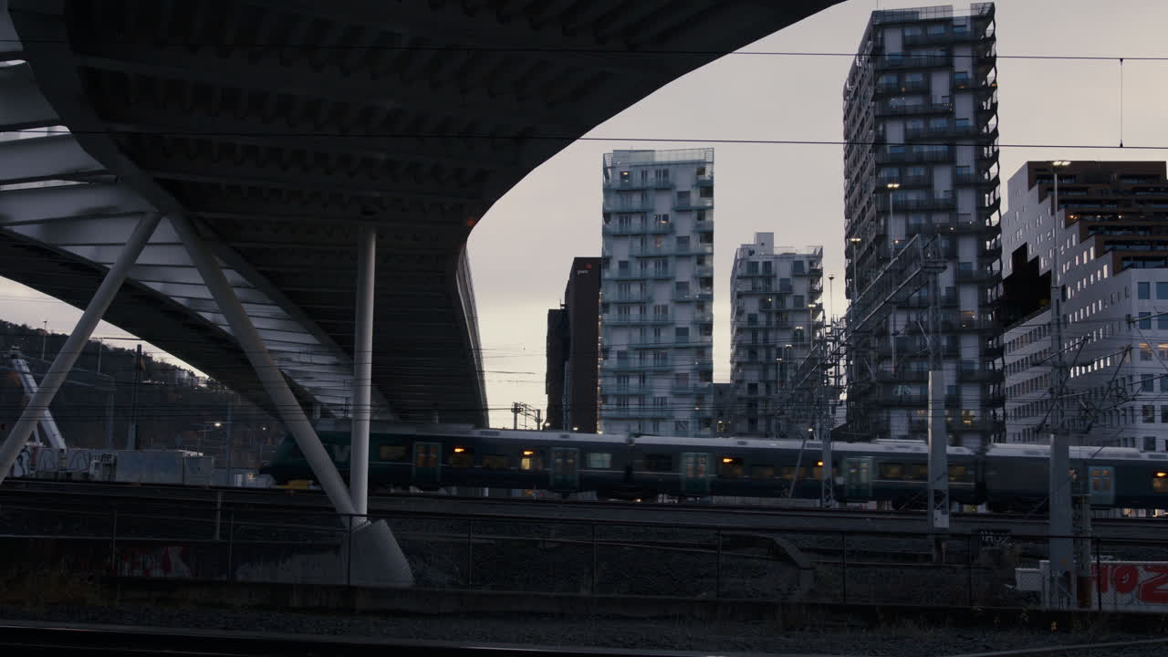 Trains moving into Oslo central station, late on a clear day in fall