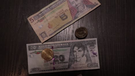 foreign currency banknotes and coins dropped on top of them