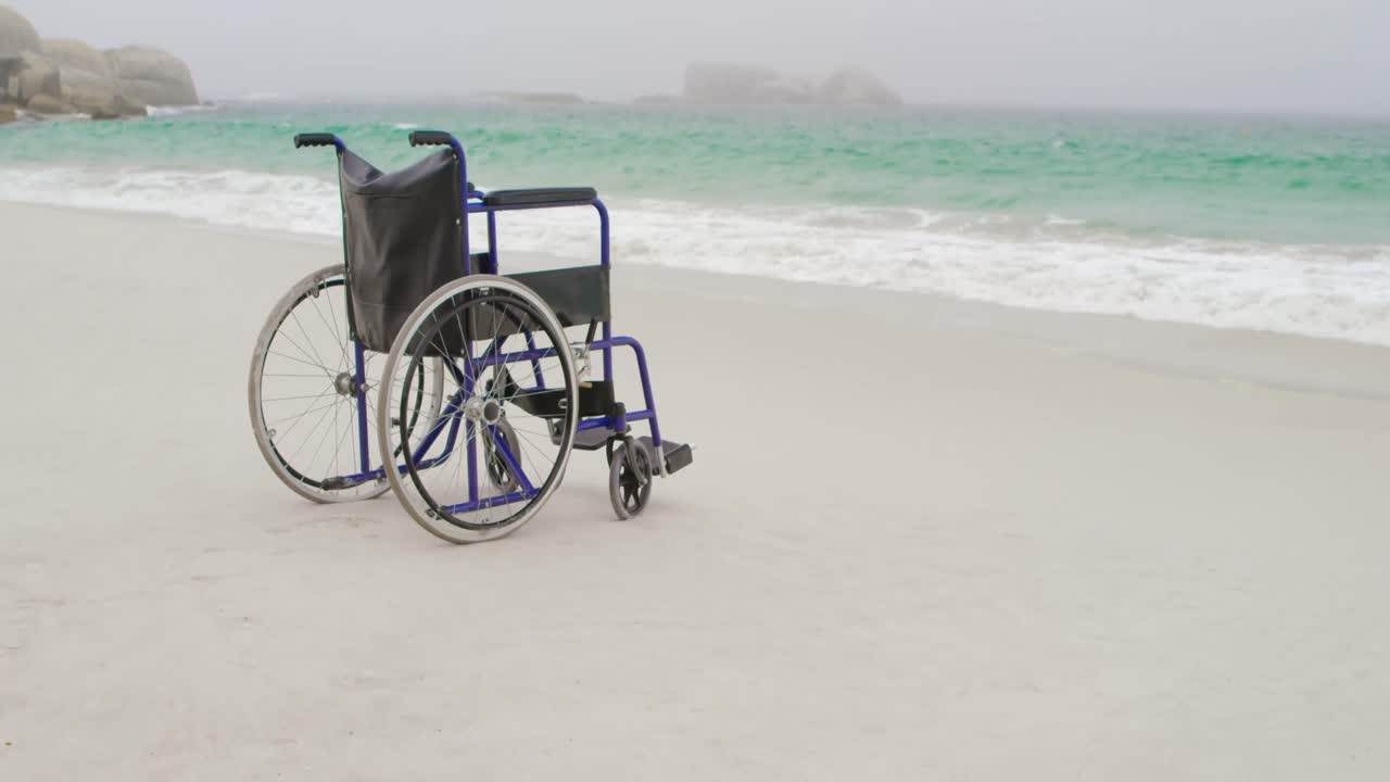 Empty wheelchair at beach on a sunny day 4k