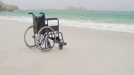 empty wheelchair at beach on a sunny day 4k