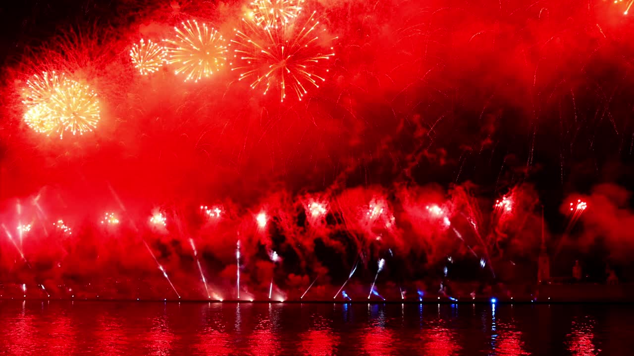 Festive colorful fireworks and illumination in dark sky with beautiful reflection in water. Holiday SCARLET SAILS