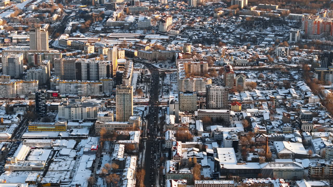 Aerial drone view of Chisinau city center, covered in snow at sunset. Winter in Moldova