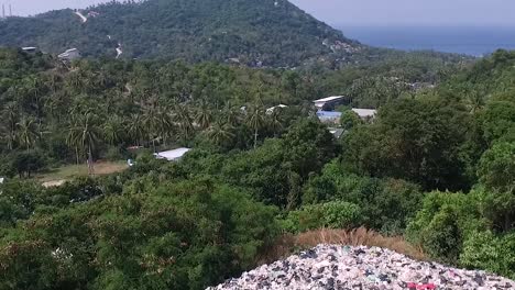 Big-mountain-of-rubbish-between-trees-Drone-descend-slowly-Thailand-1080-HD-Asia,-Thailand-Filmed-with-Sony-AX700