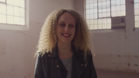 Fashionable-young-woman-in-an-abandoned-warehouse