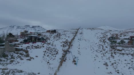 aerial rising shot revealing el colorado ski runs with farellones in the foreground