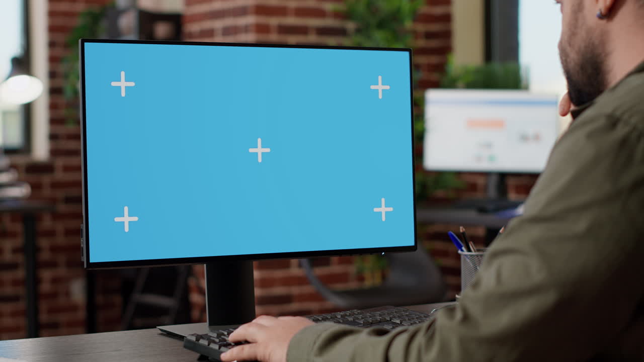Businessman working on monitor with greenscreen template