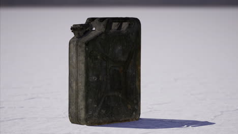 rusty jerry can stands alone on salt flat under bright sun