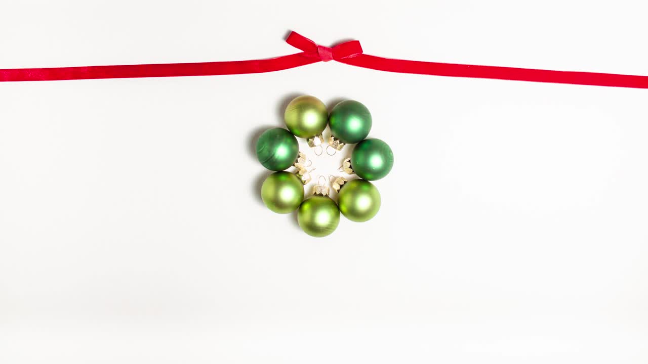 Red ribbon bow at the top and green evening balls. Christmas concept