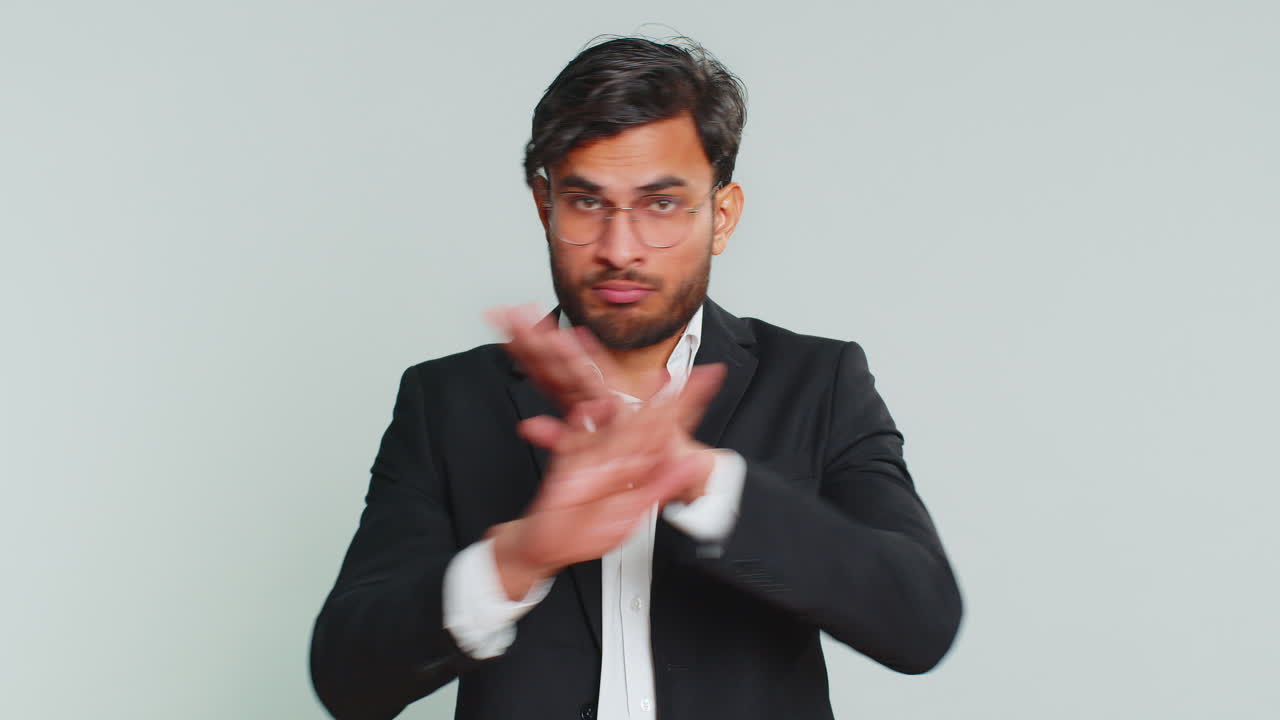 Businessman say no hold palm folded crossed hands in stop gesture warning finish prohibited access