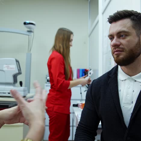 ophthalmologist consulting young man in clinic