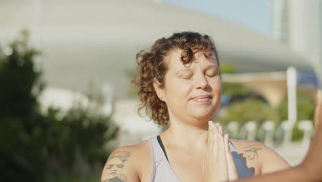 Slider-shot-of-peaceful-woman-taking-deep-breath-during-workout